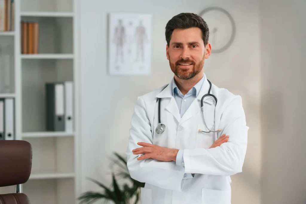 confident doctor poses with stethoscope in office utc ()