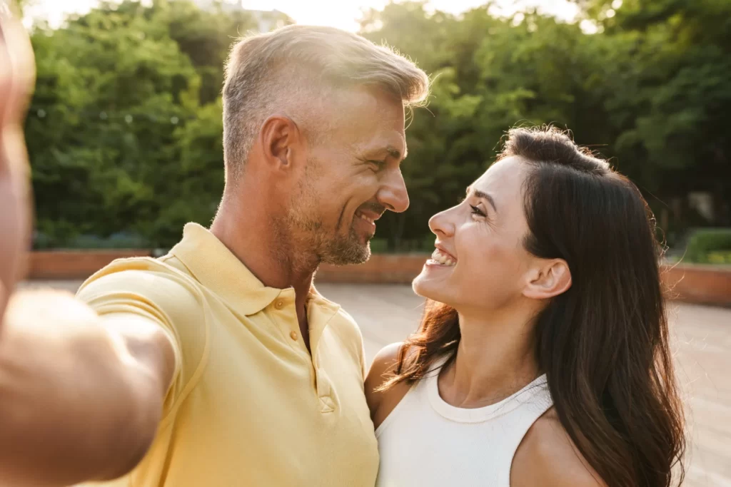 portrait of joyful middle aged couple taking selfi utc